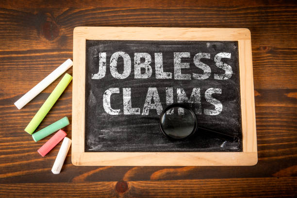 istock Jobless Claims. Miniature blackboard with text on a wooden texture background 2187425295
