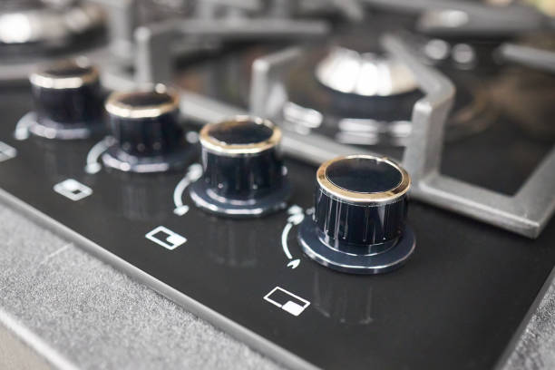 istock Black hob cooker oven grill control knobs selective focus over out of focus oven with burner background. 2187425748