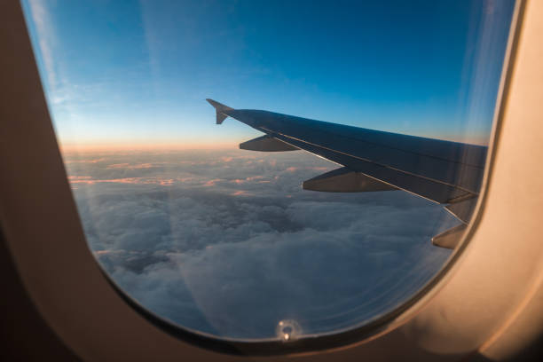 istock Looking out airplane window, a blanket of clouds, with a gradient sunset or sunrise 2187426845