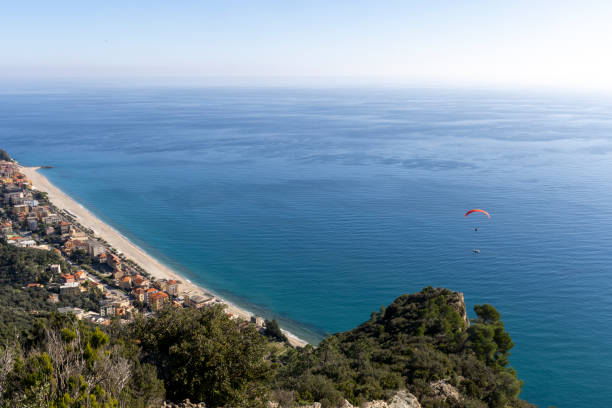 istock Elevated view of paraglider sailing over Mediterranean coastline 2187429084