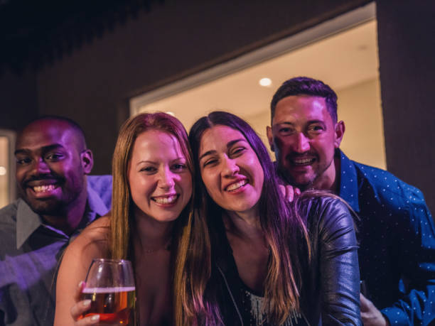 istock Four Friends Enjoying a Night Out Together Smiling 2187430630