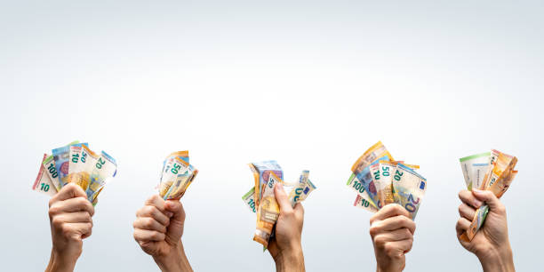 istock Hands holding Euro banknotes up in the air with copy space 2187431502