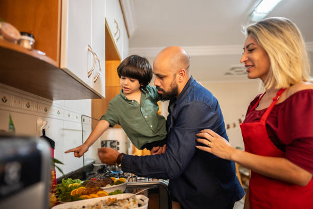 istock Parents and son cooking for christmas on kitchen at home 2187435372