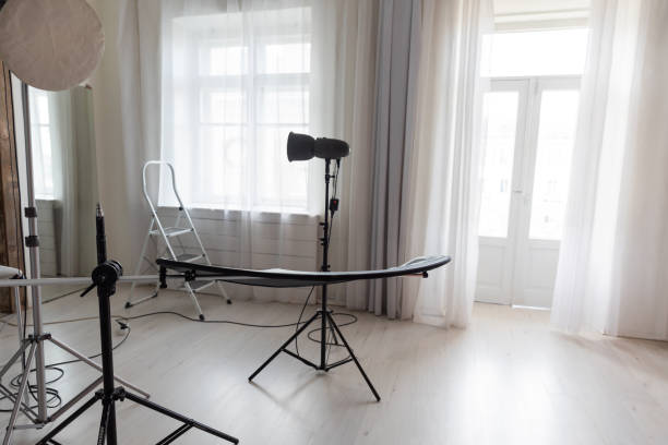 istock Photographer's equipment in a photo studio flashes backgrounds 2187436269
