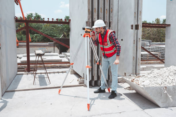 istock Architectural surveying engineers use data transfer equipment on outdoor construction sites during surveying. Surveyors telescope at construction 2187438435