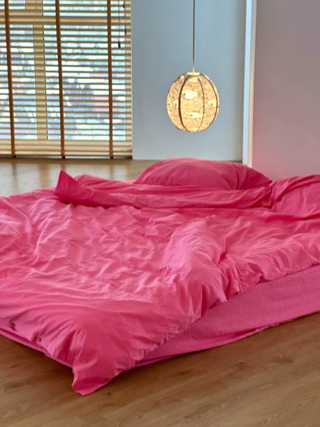 istock pink bedroom bed linen 2187439826