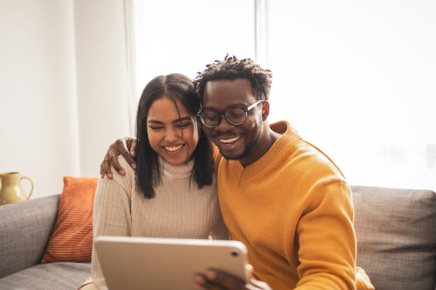 istock Happy couple enjoying a video call on a digital tablet 2187441938