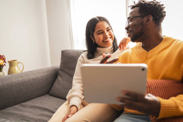 istock Happy couple spending quality time with tablet at home 2187441940
