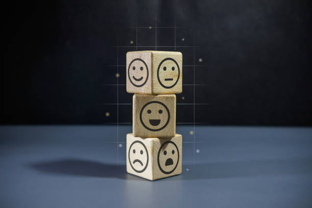 istock Stack of wooden blocks with face emoticon on dark background. Customer review satisfaction feedback concept. 2187448633