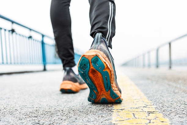 istock Unknown man running in winter day close up on shoe 2187453482
