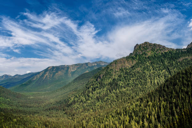 istock Forested Valley, Rock Peaks and Clouds 2187454226