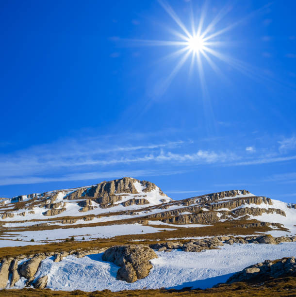 winter snowbound mountain ridge under a sparkle sun