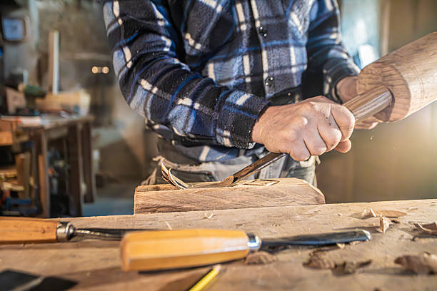 istock carpenter carving on wood plank with precision on a carpenter's bench in a rural carpentry workshop 2187455799