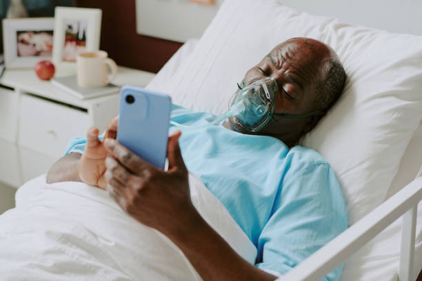 istock Senior Patient Lying in Hospital Bed Using Smartphone 2187457698