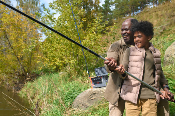 istock Father Helping Son with Fishing 2187459175