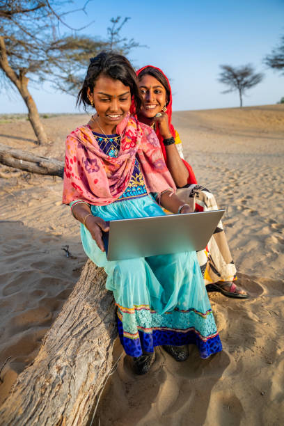 istock Happy Gypsy Indian girls using laptop, India 2187461090