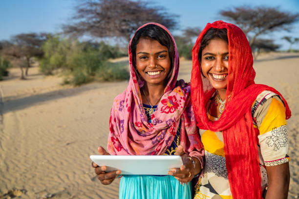 istock Happy Gypsy Indian girls using digital tablet, India 2187461102