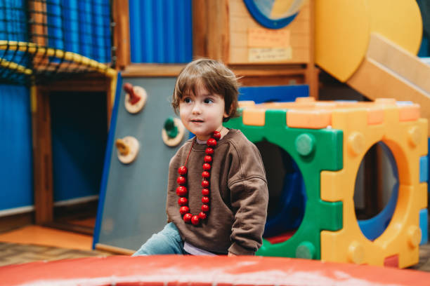 istock Baby boy playing in colorful indoor playground 2187462655
