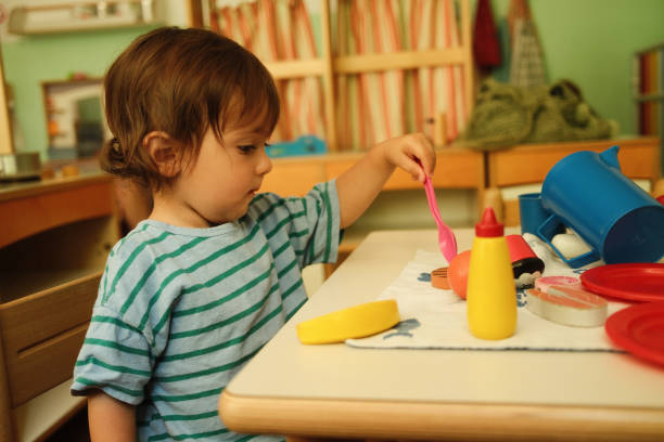 istock Baby boy playing with toy food in kindergarten setting 2187462699
