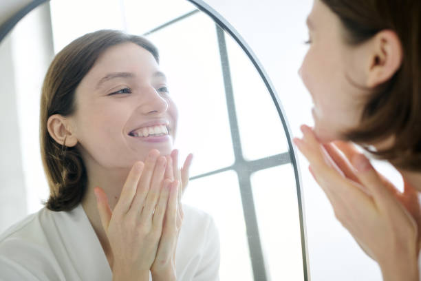 istock Cheerful Woman Admiring Her Reflection 2187463535