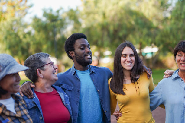 istock Group of happy multiracial people having fun hugging each other - Multi generational friendship - Community and social inclusion concept 2187466022