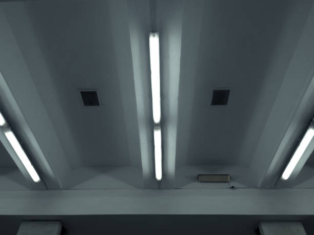 istock Fluorescent light fixtures on a concrete ribbed ceiling. 2187468230