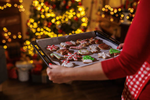 istock Festive baking with Christmas cookies in front of a decorated holiday tree 2187468497