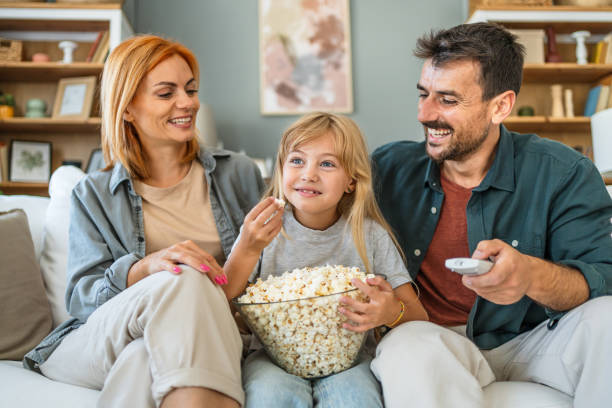 istock Happy family watching tv at home 2187470337