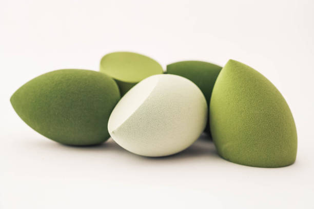 istock Green makeup sponges on a white background. A minimalist composition showcasing beauty tools for foundation blending, perfect for skincare and cosmetics themes 2187470588