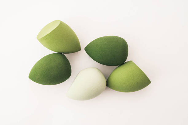 istock Green makeup sponges on a white background. A minimalist composition showcasing beauty tools for foundation blending, perfect for skincare and cosmetics themes 2187470596