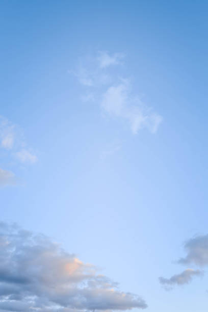 istock Clear blue sky with scattered soft clouds, featuring gentle gradients of color transitioning to a serene, tranquil atmosphere, perfect as a background or for nature-themed concepts 2187470615