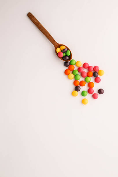 istock Chocolate round candies scattered on white isolated background 2187470781