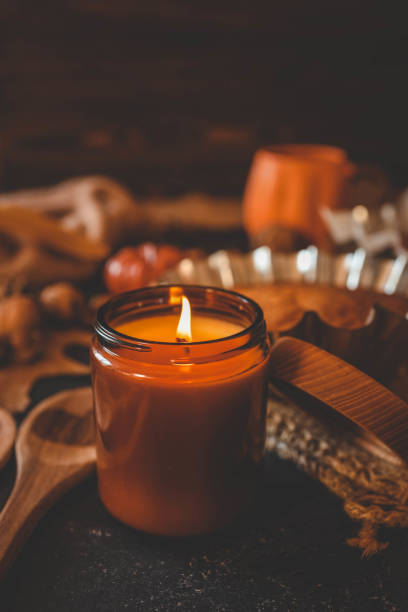 istock Burning candle with pumpkin pie scent, cozy autumn 2187471955