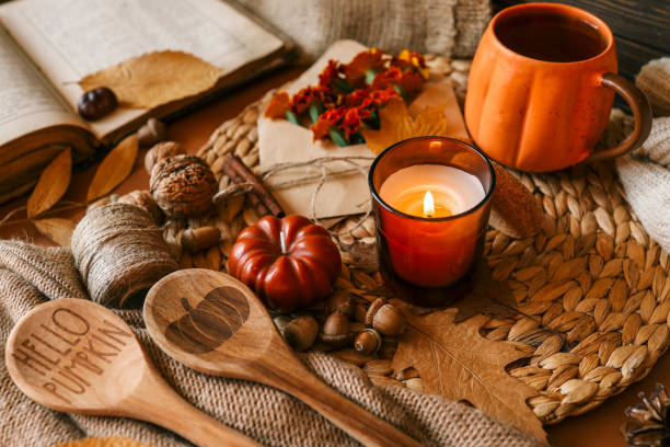 istock Burning candle in a cozy warm homey autumn atmosphere 2187472468
