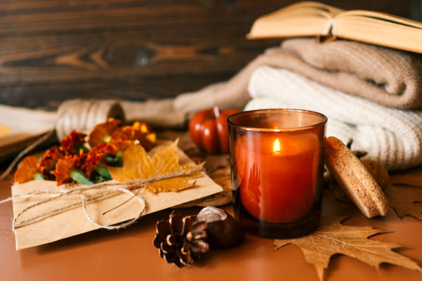 istock Burning candle in a cozy warm homey autumn atmosphere 2187472529