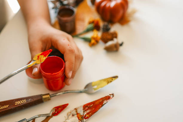 istock Creative autumn art activity with paint and natural materials like pine cones, acorns, and chestnuts, crafting seasonal decorations 2187472592