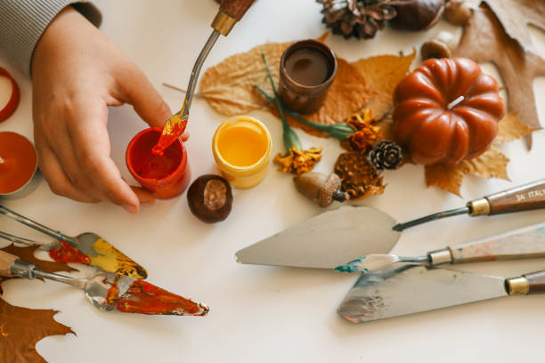 istock Creative autumn art activity with paint and natural materials like pine cones, acorns, and chestnuts, crafting seasonal decorations 2187472593