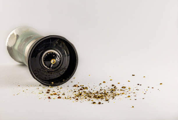 Salt and pepper in a glass container with a grinder, salt shaker, pepper shaker, salt shaker, pepper shaker,