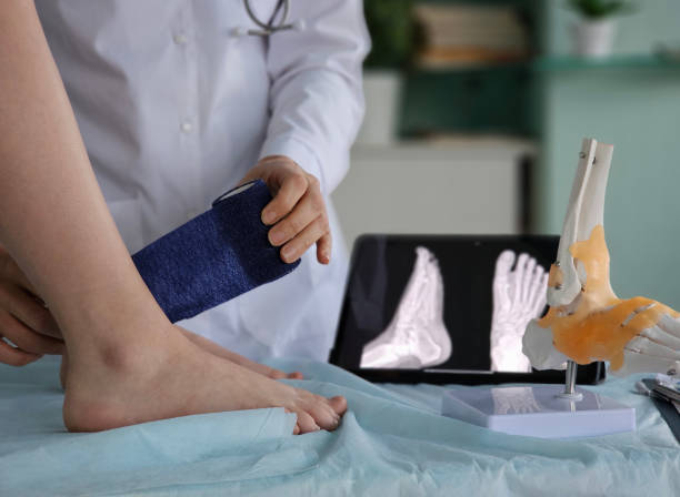 istock A traumatologist applies a bandage to an ankle 2187473857