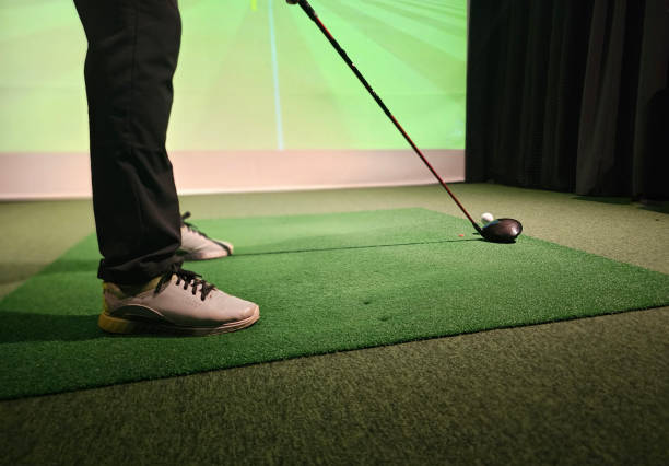 istock Professional male golfer playing golf indoors in golf simulator closeup 2187474253