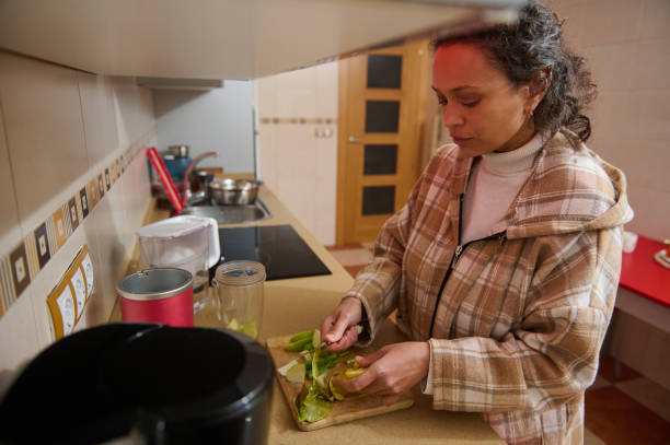 istock Woman preparing fresh vegetables in a cozy home kitchen 2187474467