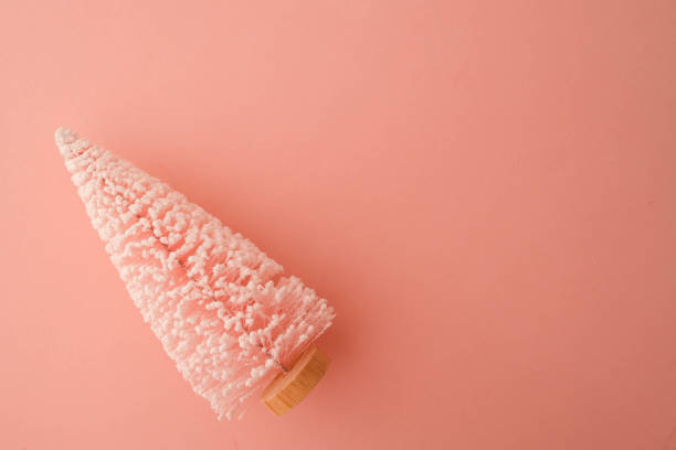 istock Minimalistic Christmas tree decoration covered in snow on a pastel pink background. Festive and clean composition perfect for holiday themes or modern designs 2187475814