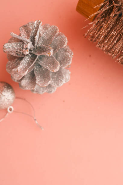 istock Minimalist flat lay composition of a metallic Christmas tree, silver pinecones, and glittery ornaments on a pastel pink background. Perfect for festive, seasonal, and holiday-themed designs 2187475845