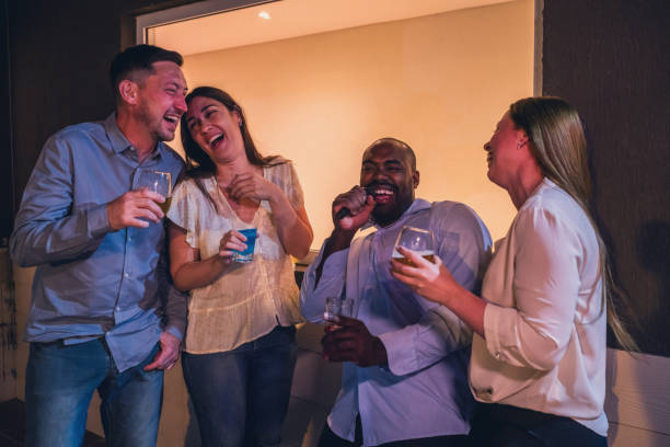 istock Group of Friends Enjoying Drinks and Laughter at a Party 2187476230