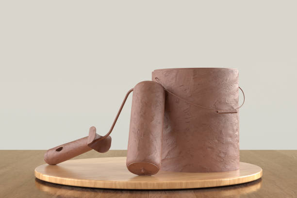 istock A brown paint roller and a brown bucket are on a wooden table 2187476633