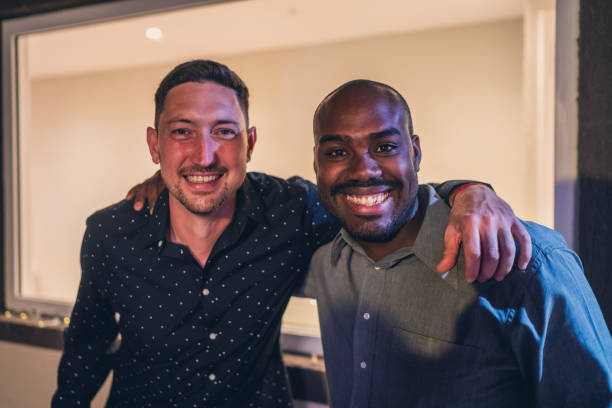 istock Friends Smiling Together at Indoor Gathering Event 2187476915