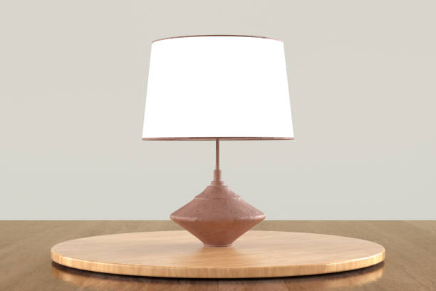istock A lamp with a white shade sits on a wooden table 2187477043