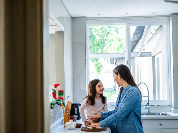 istock Mother And Daughter Baking Together In Bright Kitchen 2187477805