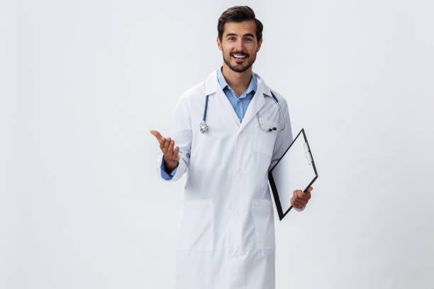 istock Man doctor in white coat with stethoscope and folder for notes and patient records smile and good test results on white isolated background, copy space, space for text, health 2187478879