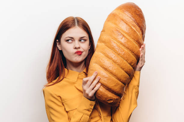 istock woman with a loaf in her hands on a light background emotions model fun 2187479064